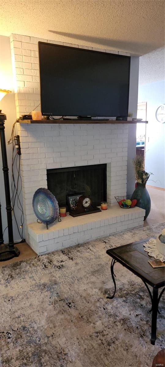 room details featuring a textured ceiling and a brick fireplace