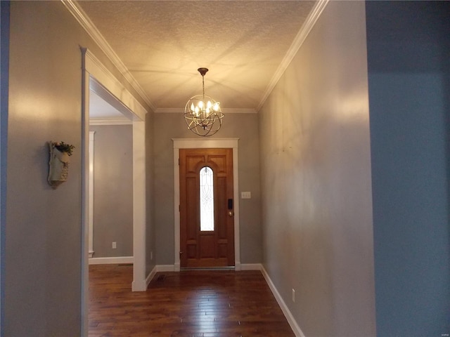 entryway featuring ornamental molding, a textured ceiling, dark wood-type flooring, and a chandelier