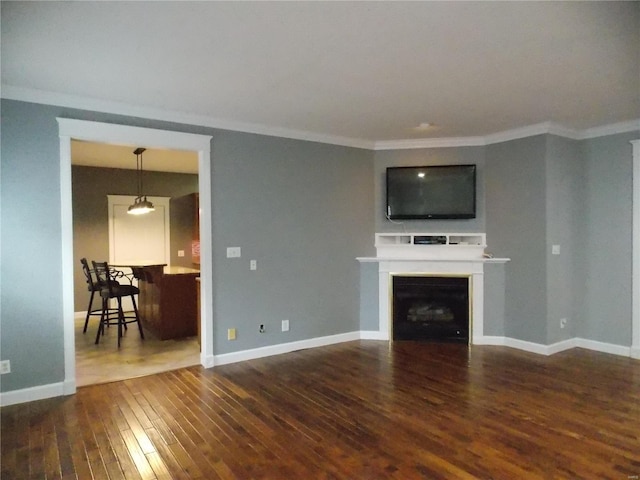 living room featuring ornamental molding and dark hardwood / wood-style floors