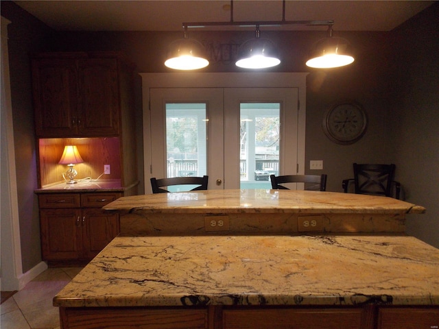 kitchen with decorative light fixtures and light tile patterned floors