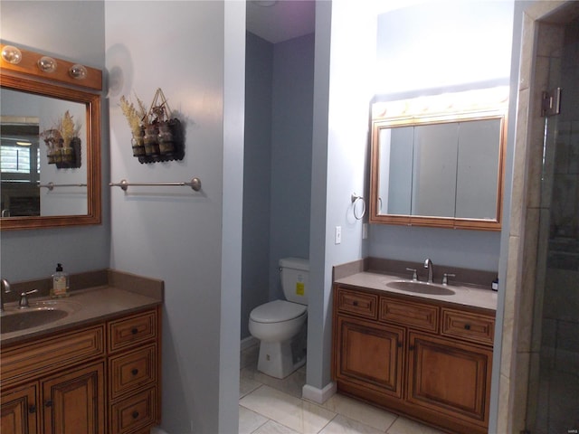 bathroom featuring tile patterned floors, vanity, and toilet