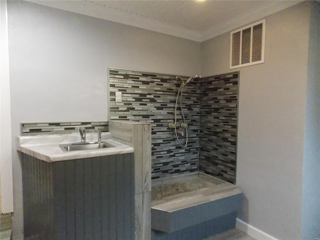 bathroom featuring a shower, crown molding, sink, and decorative backsplash