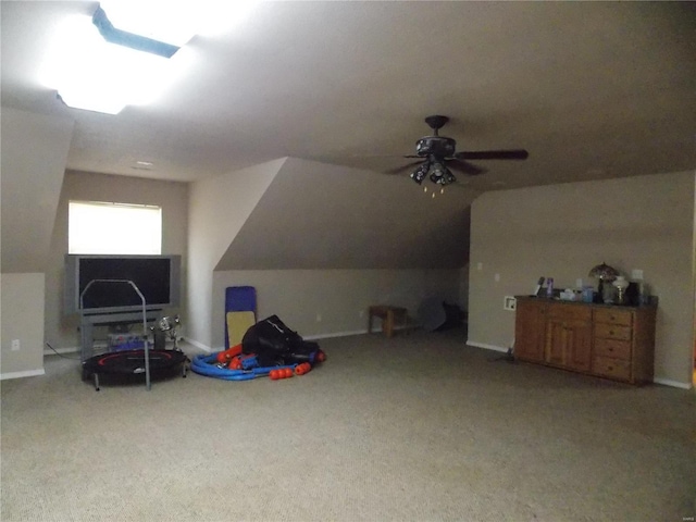 rec room with vaulted ceiling, carpet flooring, and ceiling fan