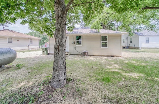 rear view of house featuring a lawn