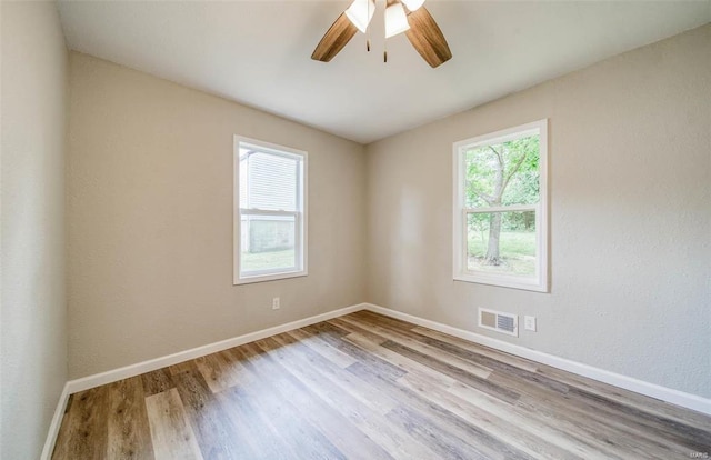 spare room with ceiling fan and light hardwood / wood-style flooring