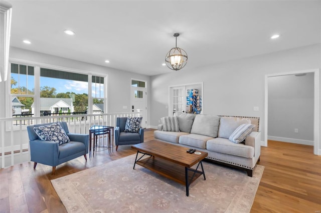 living room featuring light hardwood / wood-style floors and a chandelier