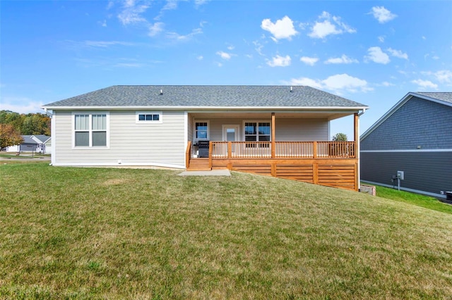 back of house with a lawn