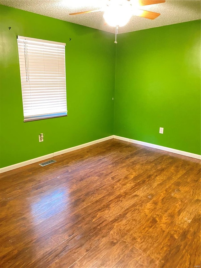 spare room featuring ceiling fan, a textured ceiling, and hardwood / wood-style floors