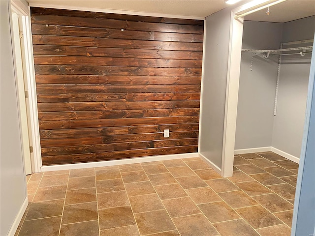 washroom featuring wood walls