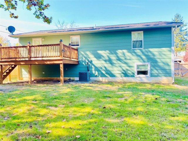 rear view of property with a yard and a deck