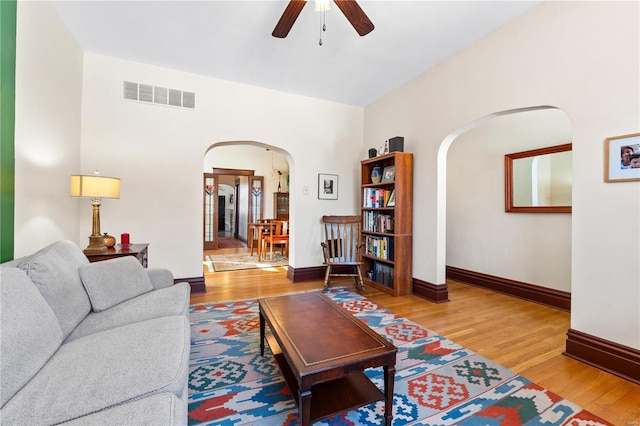 living room with ceiling fan and hardwood / wood-style floors