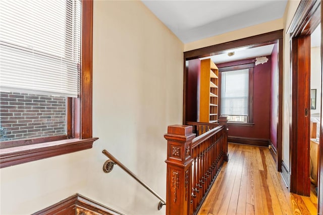 corridor with light hardwood / wood-style floors