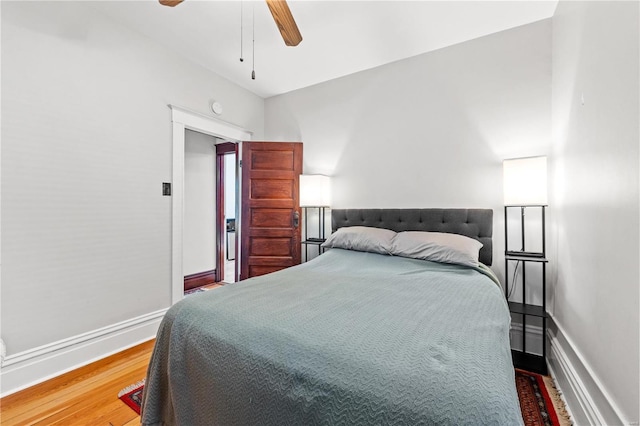 bedroom with ceiling fan and hardwood / wood-style flooring