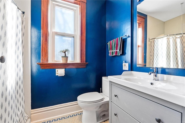 bathroom featuring toilet, vanity, and tile patterned floors