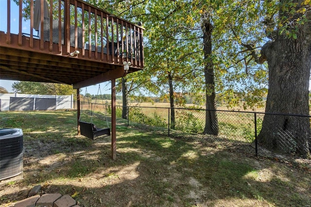 view of yard with a wooden deck and central AC unit