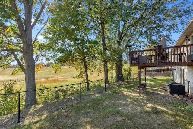 view of yard with central AC and a deck