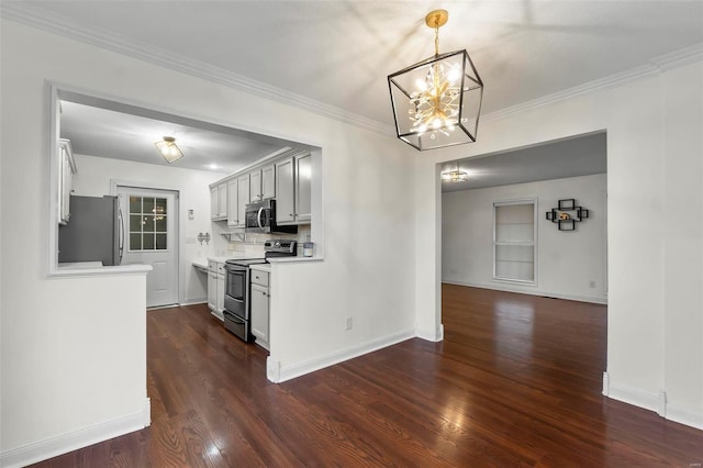 kitchen with hanging light fixtures, ornamental molding, appliances with stainless steel finishes, and dark hardwood / wood-style floors