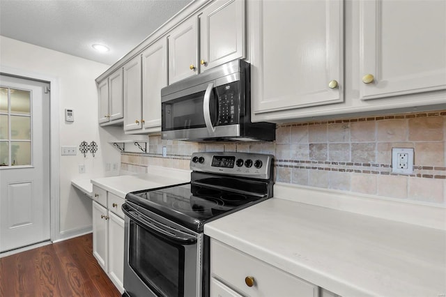 kitchen featuring tasteful backsplash, stainless steel appliances, dark hardwood / wood-style floors, and a textured ceiling