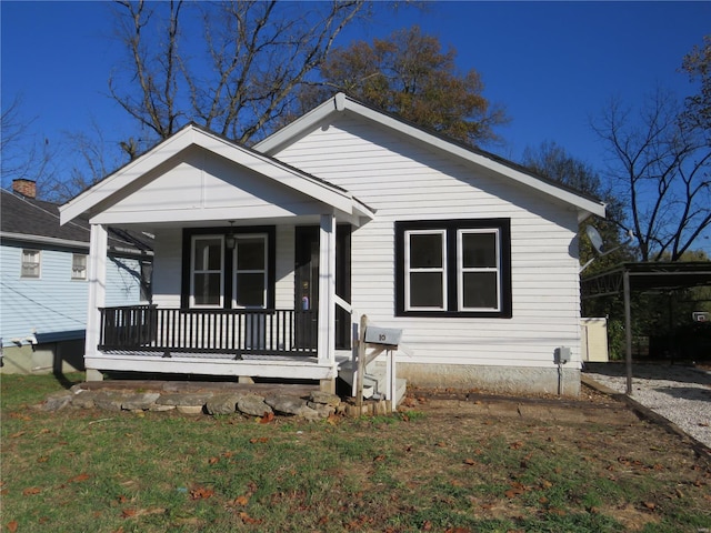 bungalow-style house with a porch and a front lawn