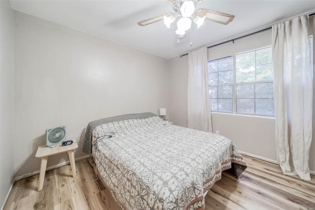 bedroom with ceiling fan and light wood-type flooring