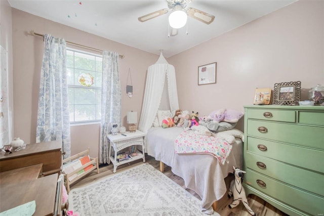 bedroom with ceiling fan and hardwood / wood-style flooring