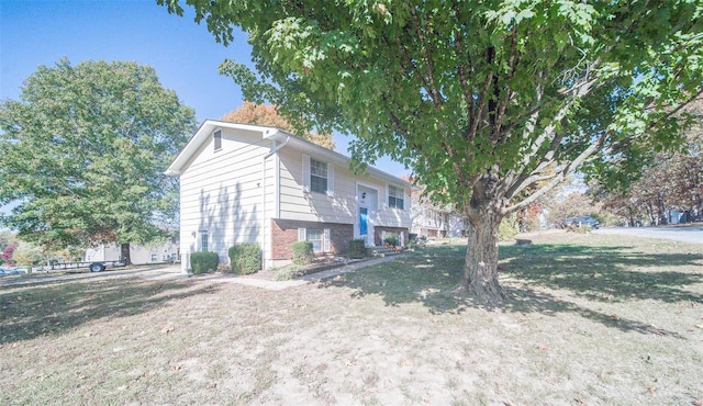 view of side of property with a lawn