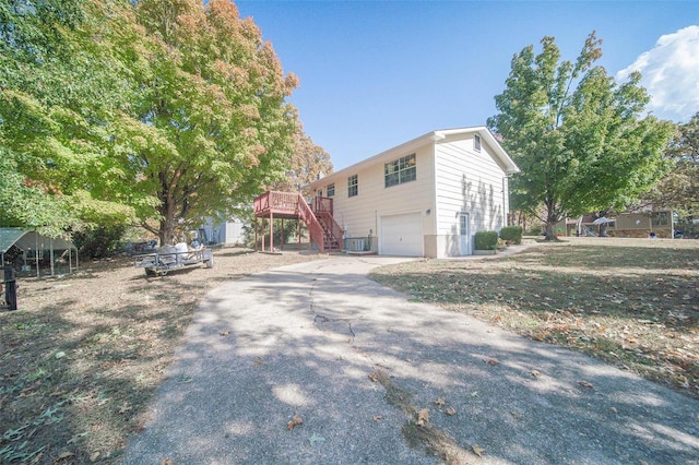 view of side of home with a wooden deck and a garage