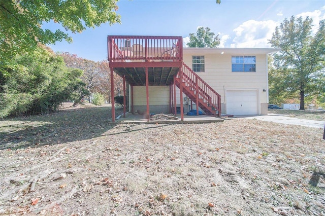 rear view of house with a garage and a deck