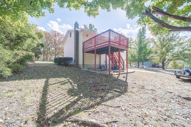 rear view of property featuring a wooden deck