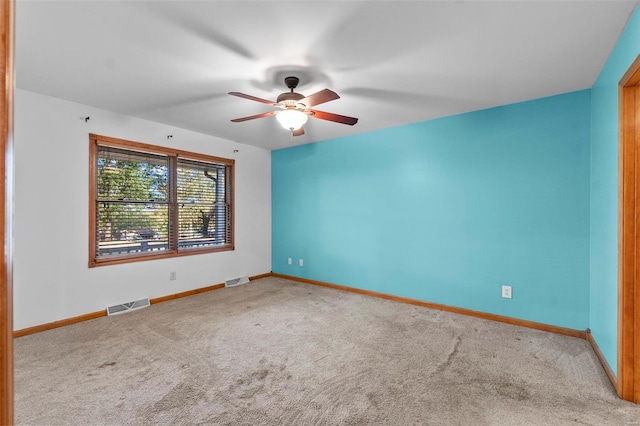 spare room with carpet and ceiling fan