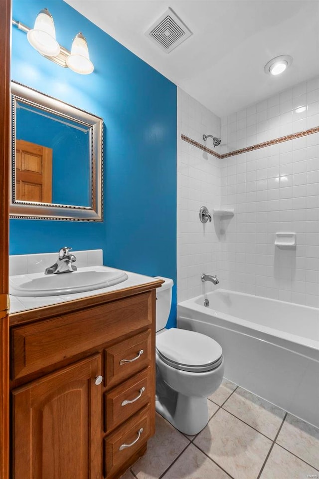 full bathroom with vanity, tiled shower / bath combo, toilet, and tile patterned flooring