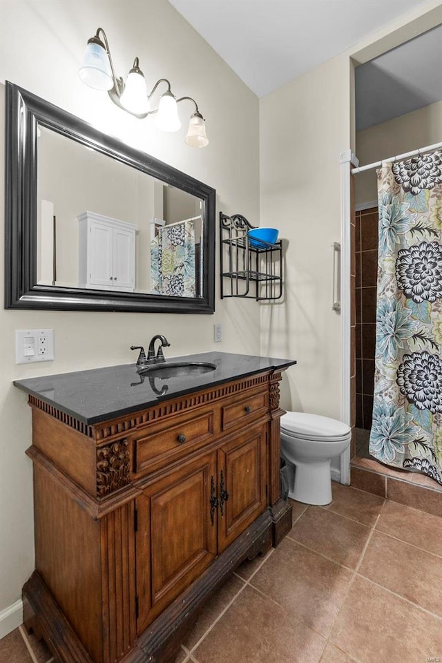 bathroom featuring toilet, curtained shower, vanity, and tile patterned flooring