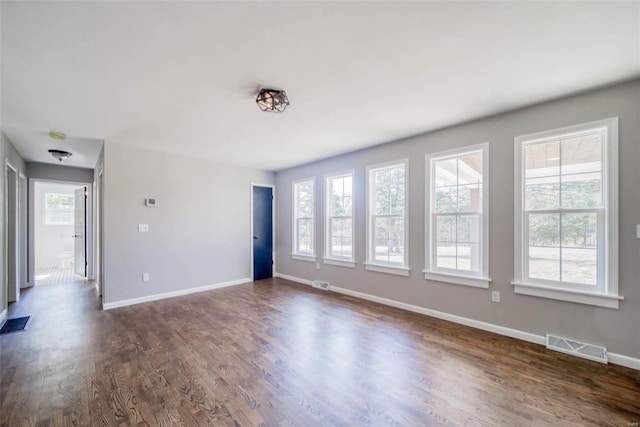 empty room with dark hardwood / wood-style floors