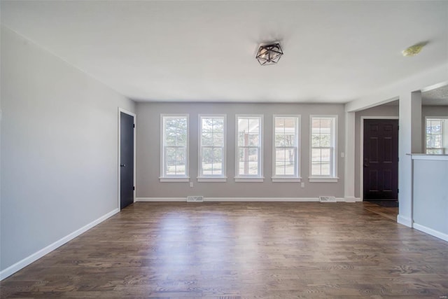 empty room featuring dark wood-type flooring