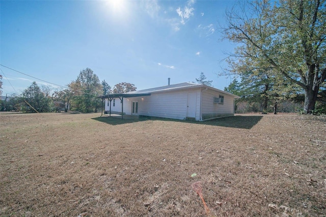 rear view of house featuring a yard