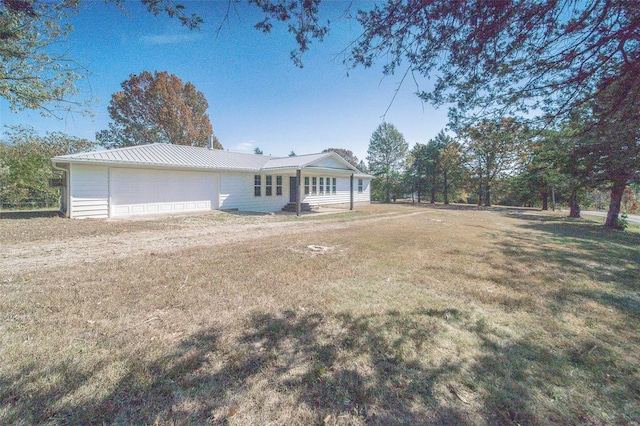 exterior space with a garage and a lawn