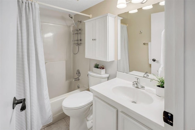 full bathroom with tile patterned floors, shower / bath combo with shower curtain, vanity, and toilet