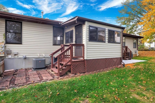 exterior space featuring a lawn and central AC