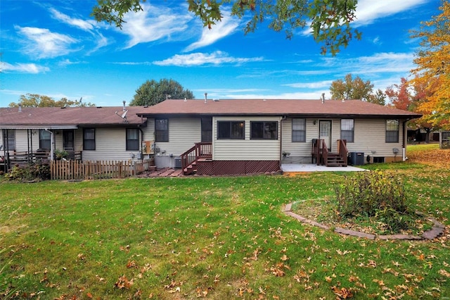 view of front of home featuring central AC and a front lawn