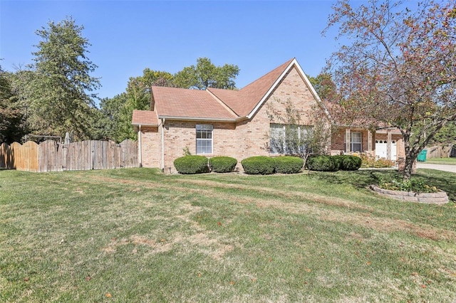 front facade featuring a front yard and a garage