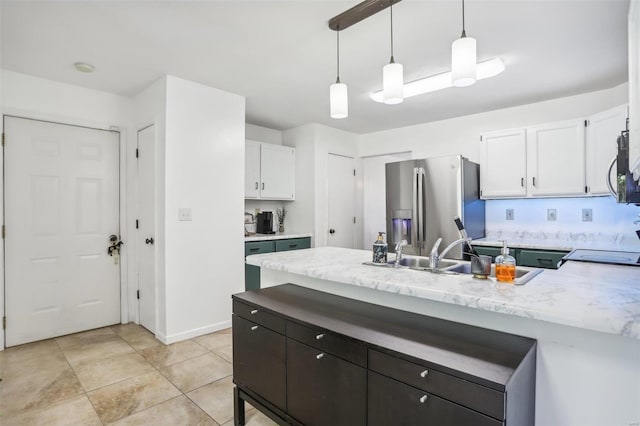 kitchen with light tile patterned floors, white cabinetry, sink, pendant lighting, and stainless steel appliances