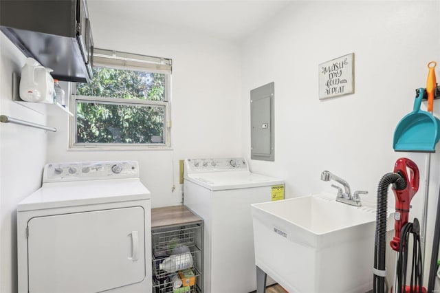 laundry area featuring sink, electric panel, and washing machine and clothes dryer