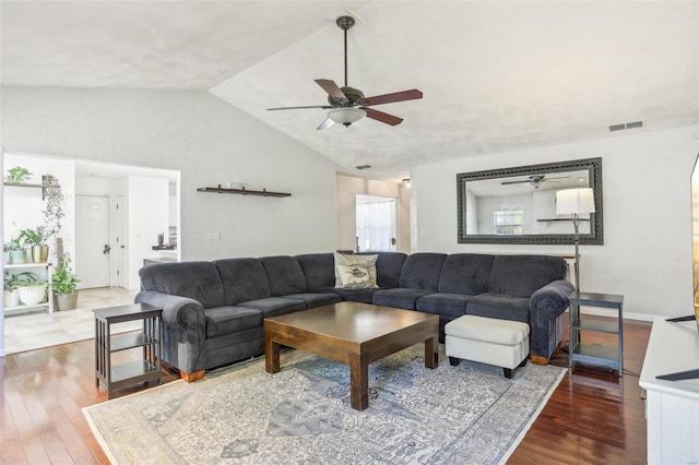 living room with hardwood / wood-style floors, ceiling fan, and vaulted ceiling