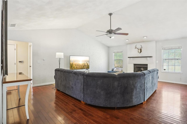 living room with a fireplace, lofted ceiling, plenty of natural light, and dark hardwood / wood-style floors