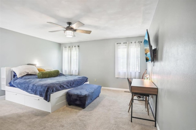 bedroom with ceiling fan and light colored carpet