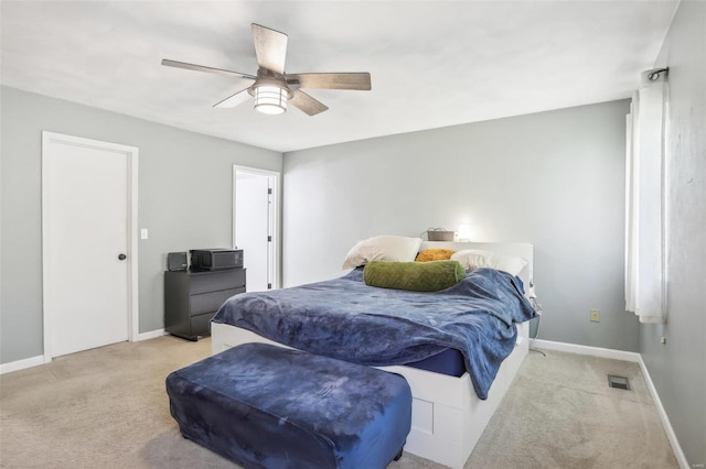 bedroom featuring light carpet and ceiling fan