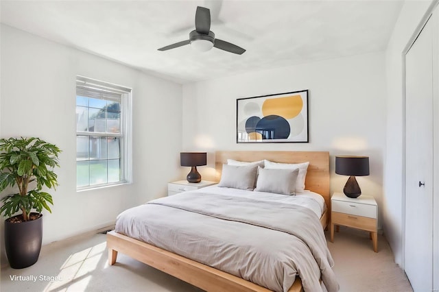 bedroom with light carpet, a closet, and ceiling fan