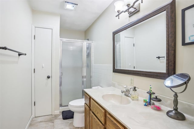 bathroom with toilet, vanity, tile patterned floors, and a shower with door