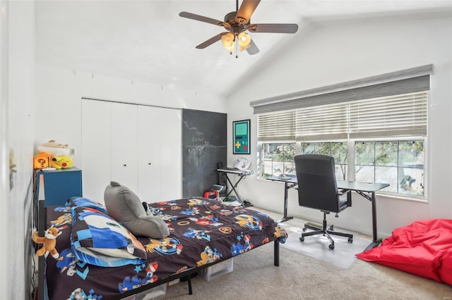 bedroom with a closet, ceiling fan, vaulted ceiling, and carpet floors