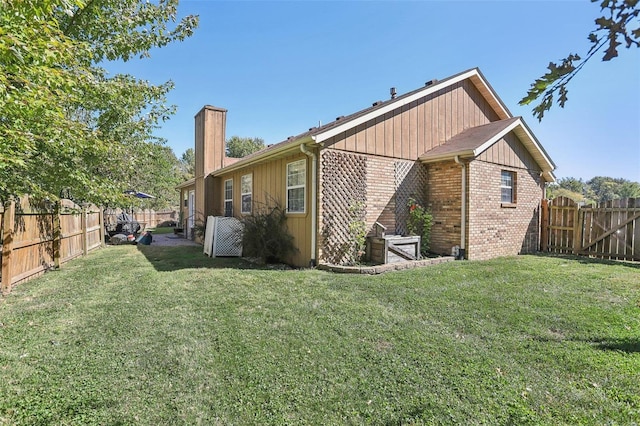 rear view of property featuring a yard